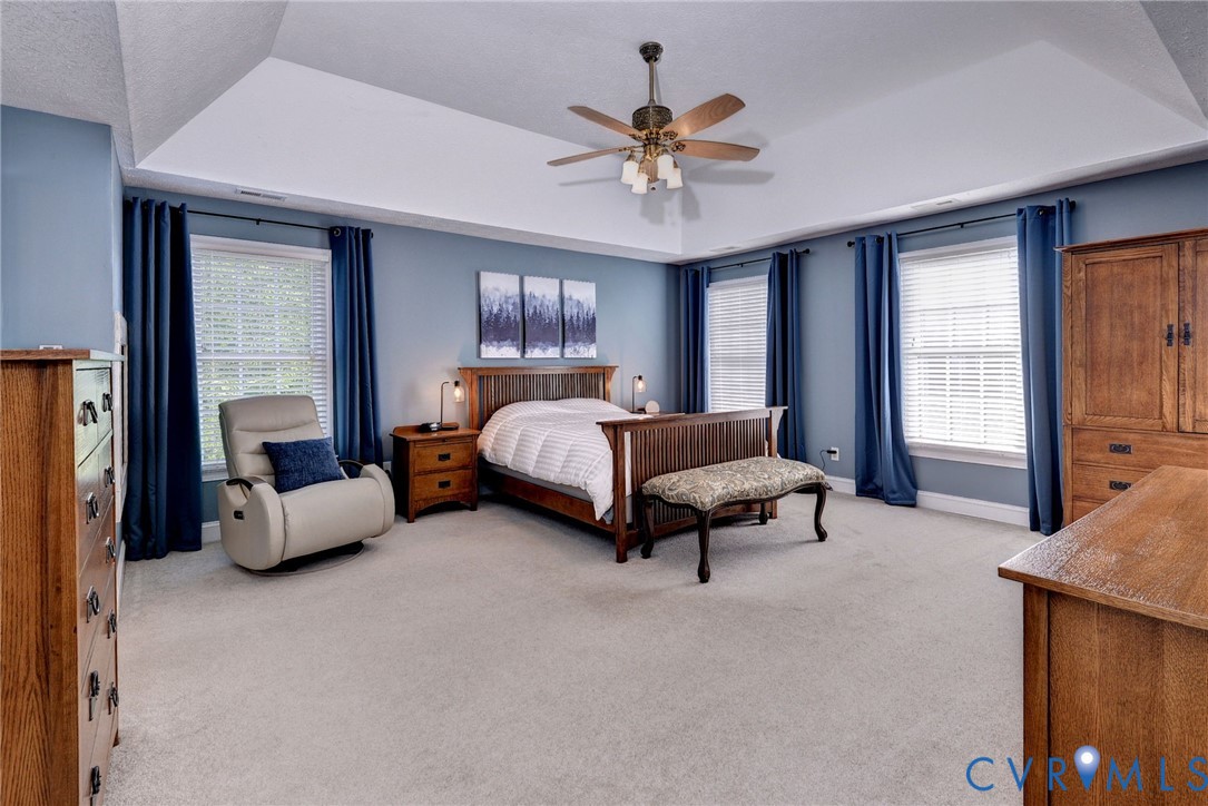 4015 Cold Spring Road Williamsburg, VA 23188 - Photo 24 of 57 Spacious carpeted room featuring a tray ceiling wi