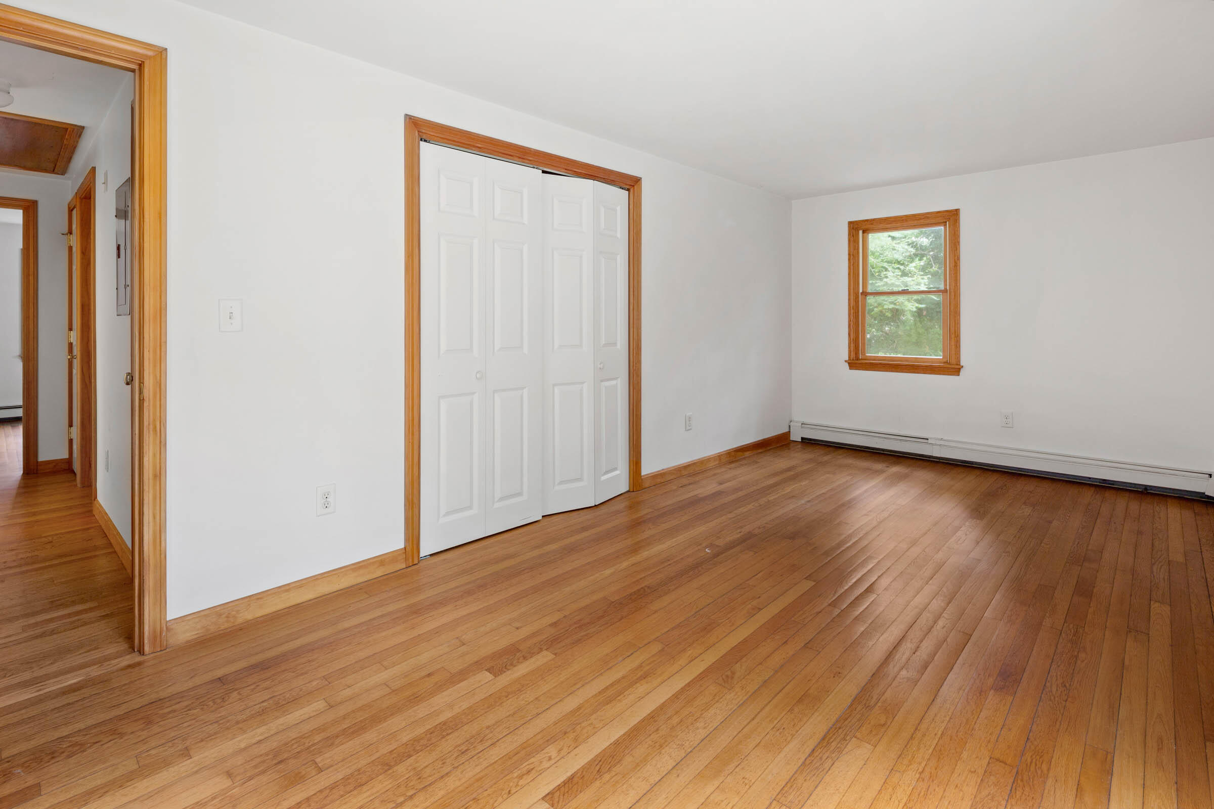 143 Tonset Road Orleans, MA 02653 - Photo 13 of 18 an empty room with wooden floor and windows
