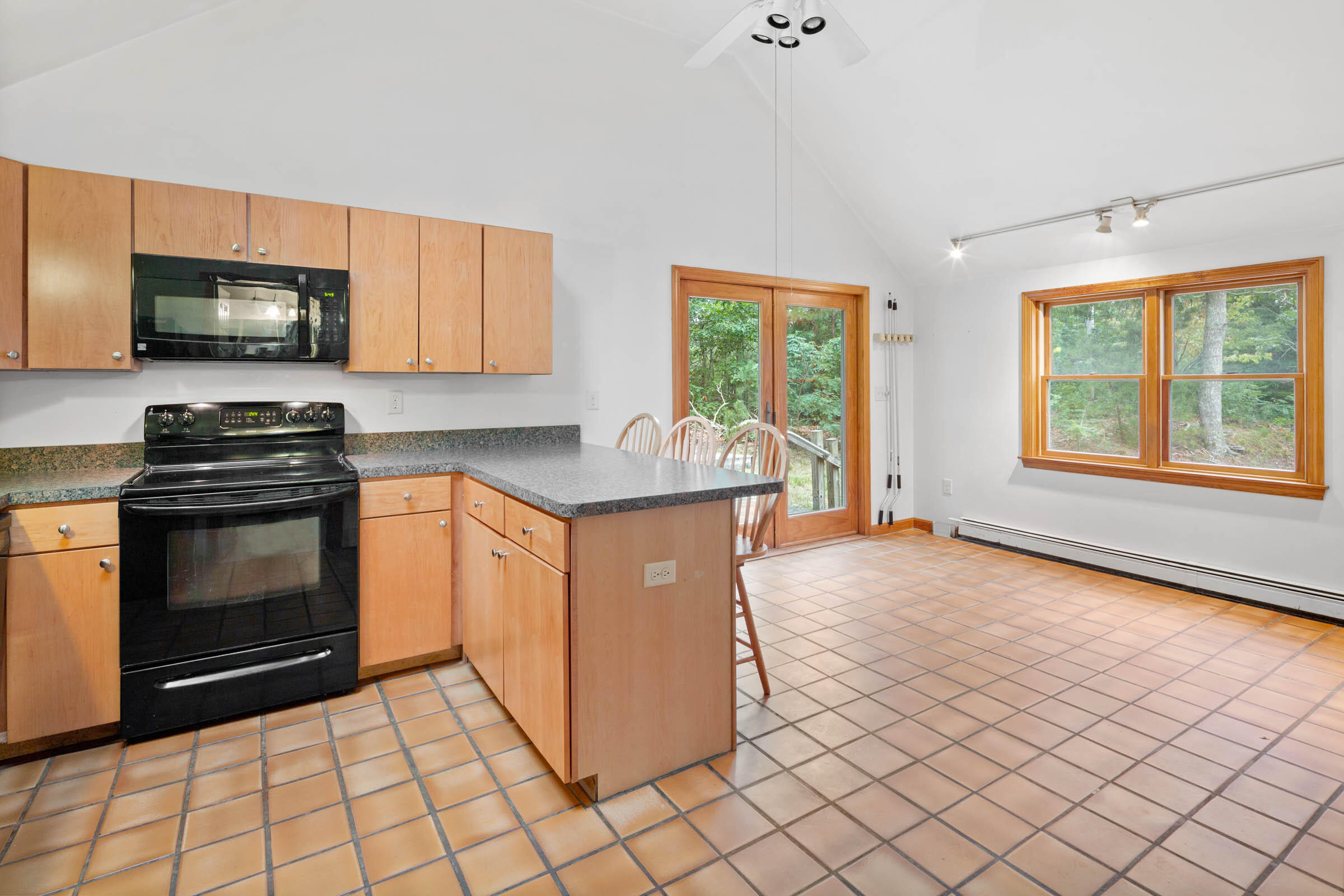 143 Tonset Road Orleans, MA 02653 - Photo 9 of 18 a kitchen with stainless steel appliances granite countertop a stove a sink and a microwave