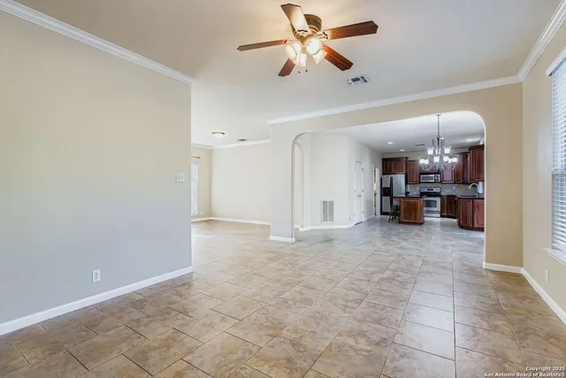 a view of a livingroom with furniture and a ceiling fan