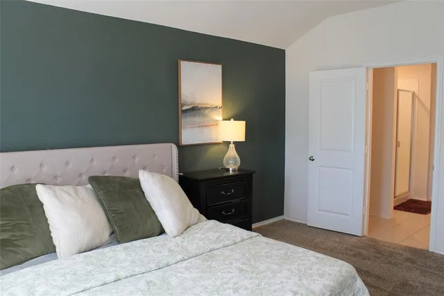 a bedroom with a bed and window