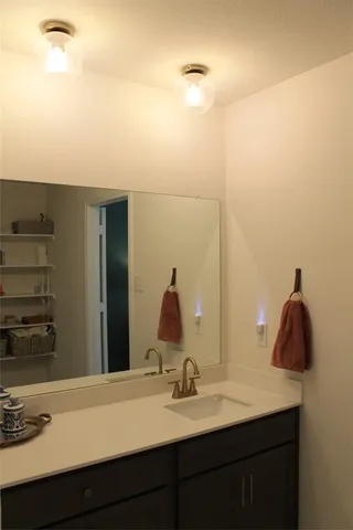 a bedroom with a bed and a lamp