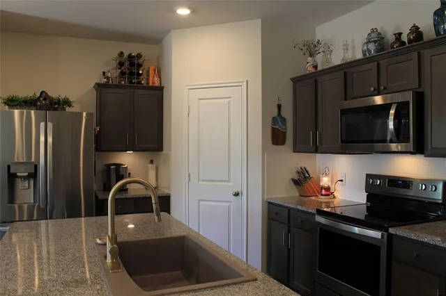 a kitchen with a sink and refrigerator