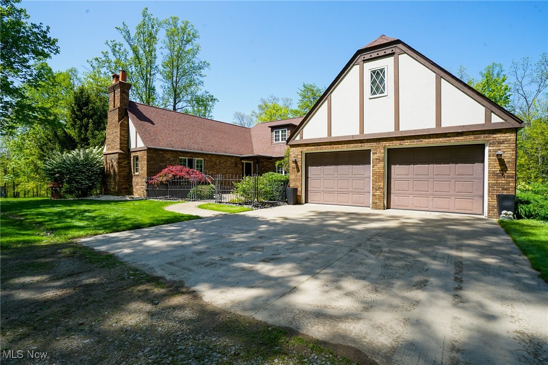 7780 Knauf Road Canfield, OH 44406 - Photo 35 of 48 Tudor home featuring brick siding, stucco siding, a chimney, and a front yard