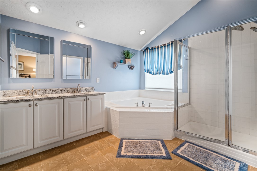 55 Janney Lane Springboro, OH 45066 - Photo 26 of 38 This serene bathroom offers a spacious soaking tub and walk-in shower for ultimate relaxation.
