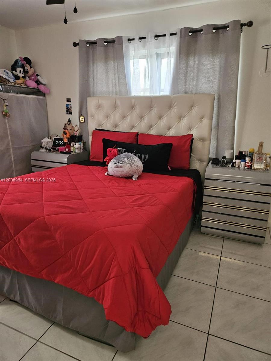 8620 Southwest 149th Avenue, Unit 418 Miami, FL 33193 - Photo 3 of 9 a bedroom with a bed and a dresser