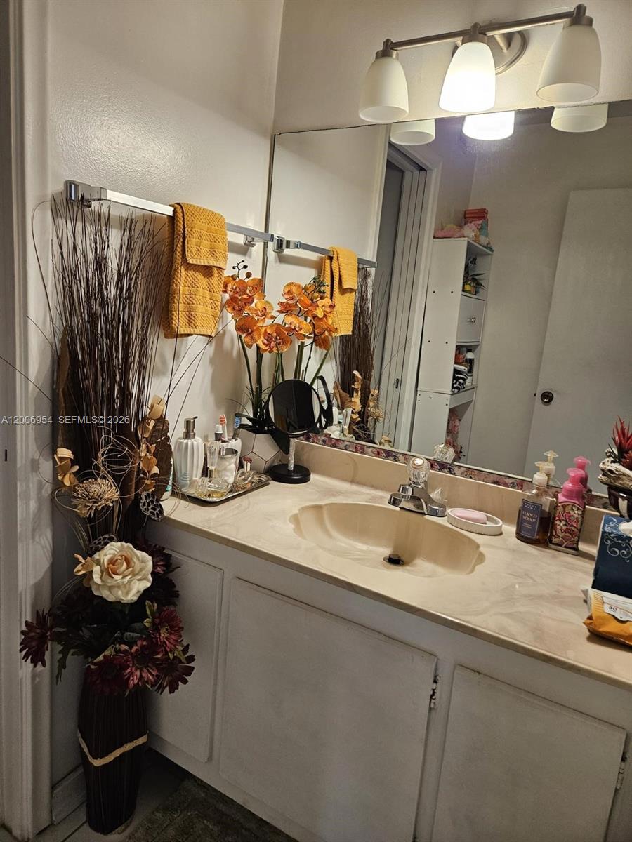 8620 Southwest 149th Avenue, Unit 418 Miami, FL 33193 - Photo 5 of 9 a bathroom with a sink double vanity and mirror
