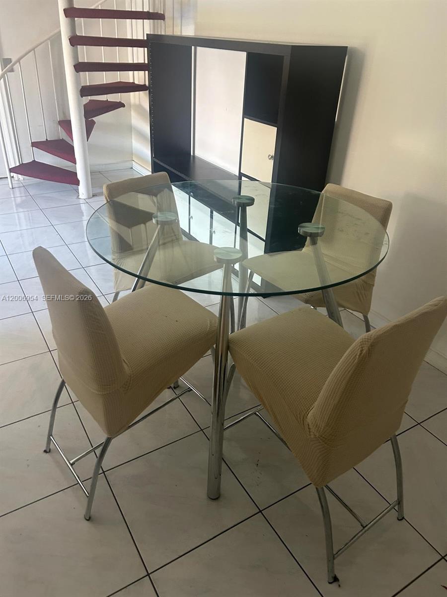 8620 Southwest 149th Avenue, Unit 418 Miami, FL 33193 - Photo 8 of 9 a living room with table chairs and wooden floor