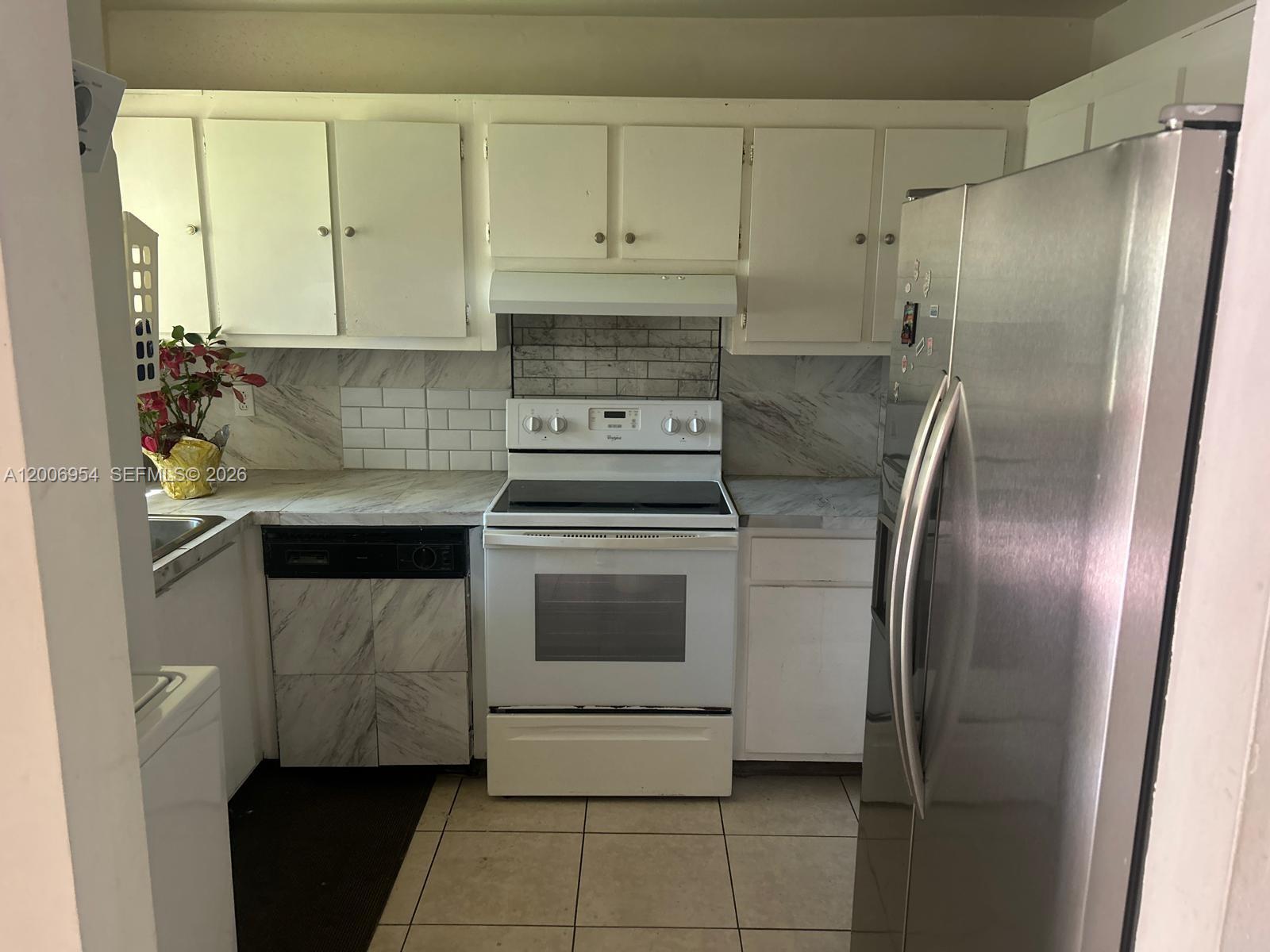 8620 Southwest 149th Avenue, Unit 418 Miami, FL 33193 - Photo 9 of 9 a kitchen with white cabinets and stainless steel appliances
