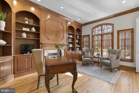 a living room with furniture a large window and a fireplace