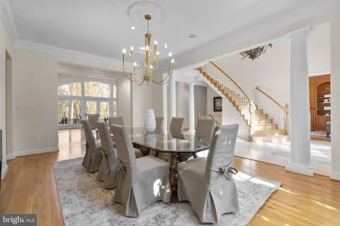 a living room with furniture a fireplace and a floor to ceiling window