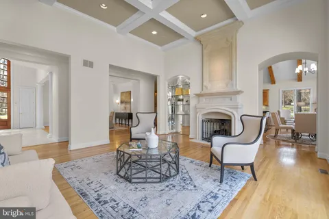a kitchen with stainless steel appliances granite countertop a stove top oven a sink a dining table and chairs with wooden floor