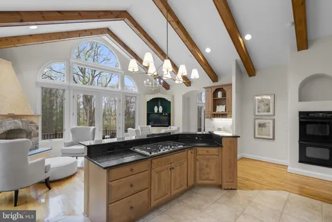 a bathroom with a granite countertop sink a mirror and a shower