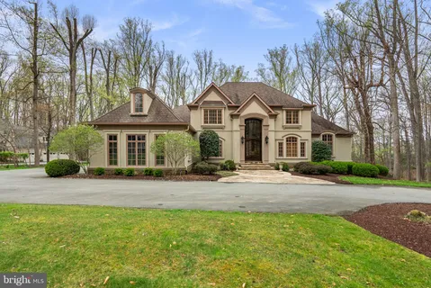 a front view of a house with yard and green space