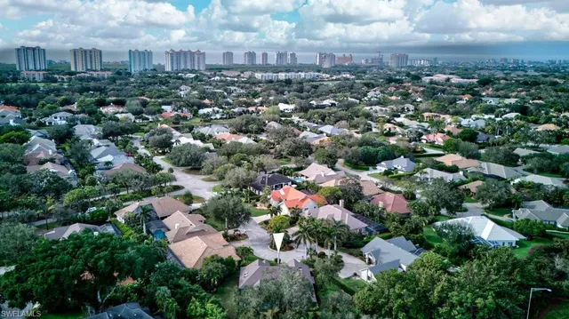 an aerial view of residential houses with city view