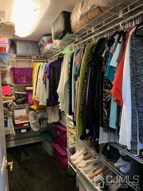 134 Normandy Road Colonia, NJ 07067 - Photo 22 of 45 a view of walk in closet with clothes and shoes