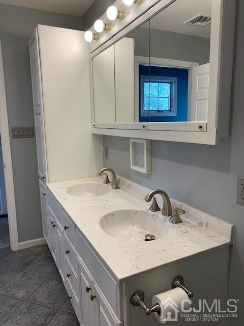 134 Normandy Road Colonia, NJ 07067 - Photo 24 of 45 a bathroom with a sink and a mirror