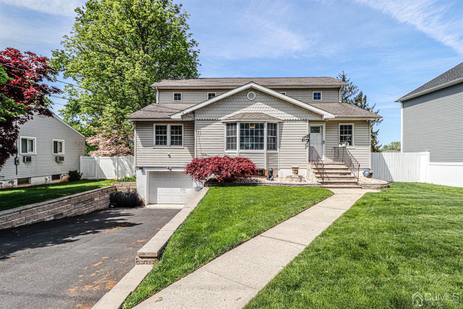 134 Normandy Road Colonia, NJ 07067 - Photo 42 of 45 a front view of a house with garden