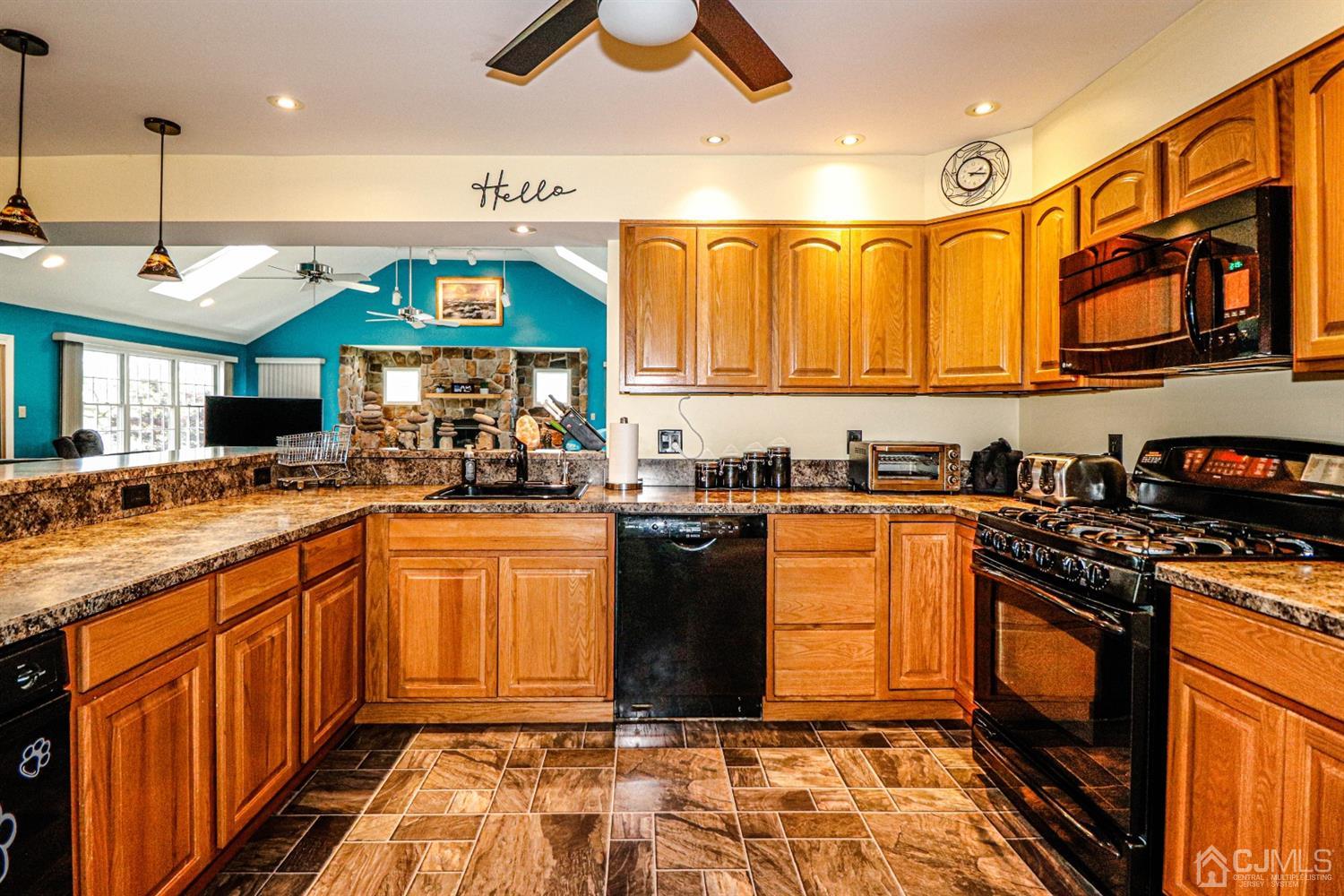 134 Normandy Road Colonia, NJ 07067 - Photo 9 of 45 a kitchen with stainless steel appliances granite countertop a stove a sink and a microwave