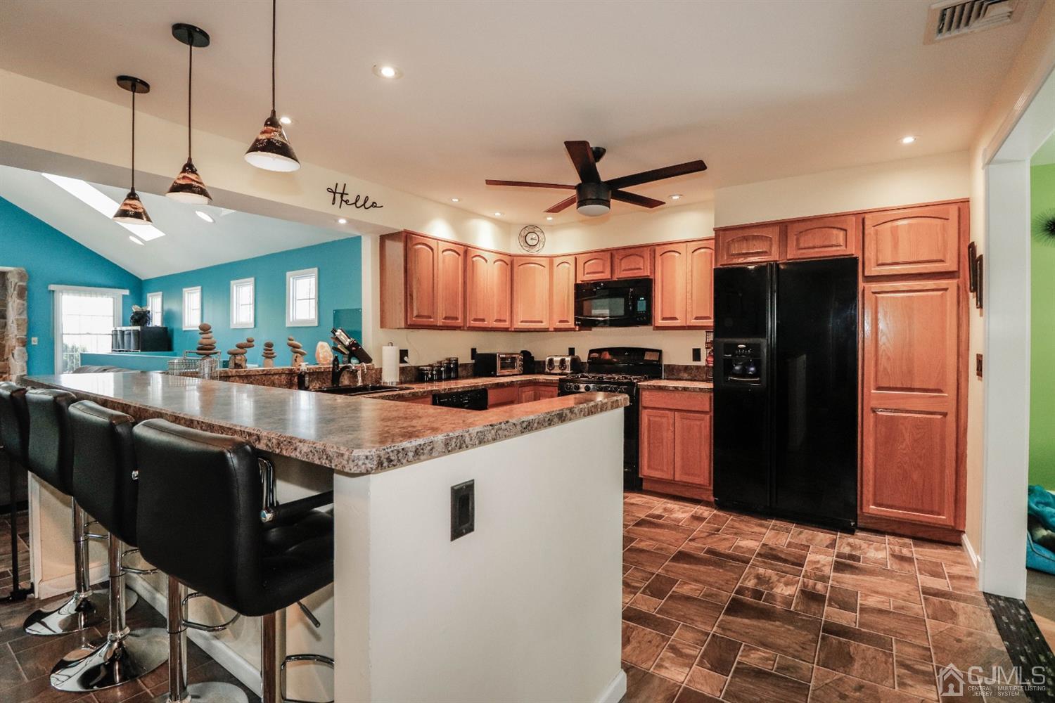 134 Normandy Road Colonia, NJ 07067 - Photo 10 of 45 a kitchen with stainless steel appliances granite countertop a refrigerator a sink a stove a dining table and chairs