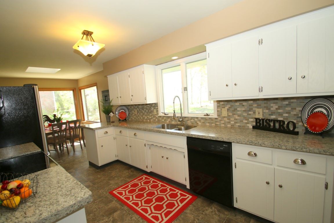 1266 Roxbury Road Rockford, IL 61107 - Photo 8 of 24 a large white kitchen with a white cabinets