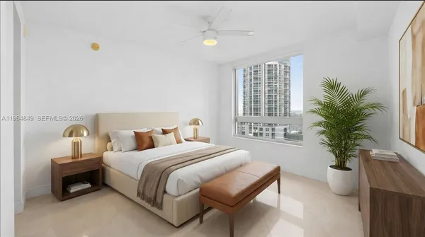 a bedroom with bed and a potted plant