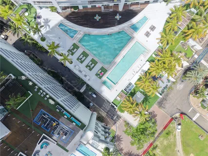 a view of swimming pool with outdoor seating and a tall buildings