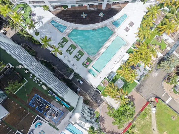 a view of swimming pool with outdoor seating and a tall buildings