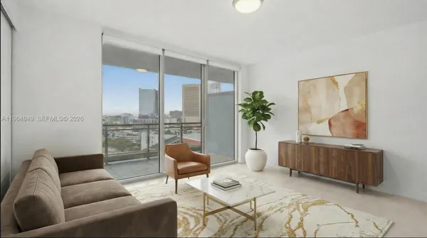 a living room with furniture and a potted plant