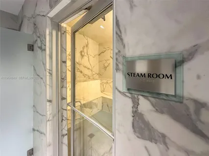 a bathroom with a large tub shower and double vanity
