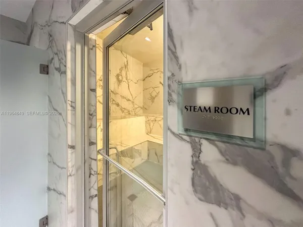 a bathroom with a large tub shower and double vanity
