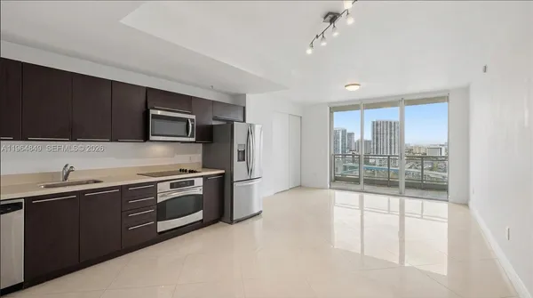 a kitchen with stainless steel appliances granite countertop a stove and a sink