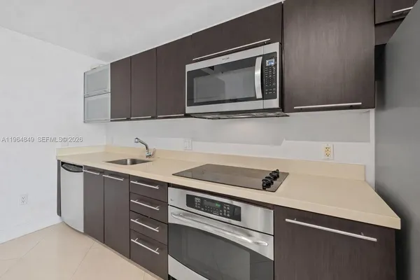 a kitchen with a sink and a microwave