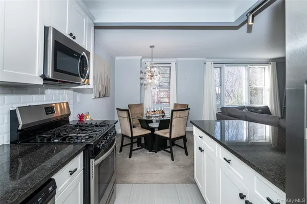 a kitchen with a stove a sink and a microwave