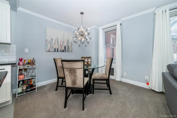 a dining room with furniture and chandelier