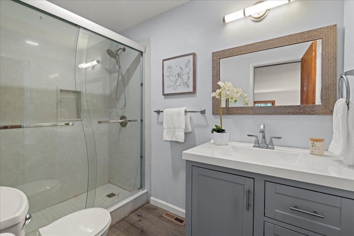 19005 Old Vineyard Road Los Gatos, CA 95033 - Photo 21 of 51 a bathroom with a sink toilet a mirror and shower