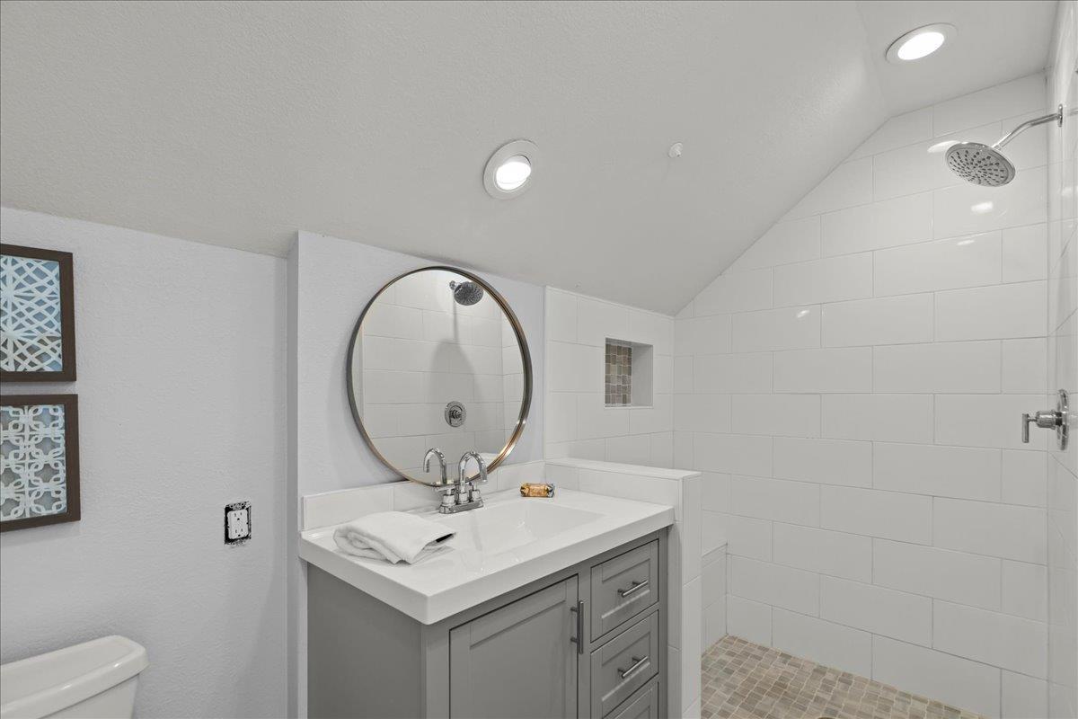 19005 Old Vineyard Road Los Gatos, CA 95033 - Photo 36 of 51 a bathroom with a sink a mirror and a toilet
