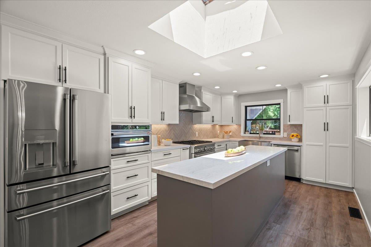 19005 Old Vineyard Road Los Gatos, CA 95033 - Photo 10 of 51 a kitchen with white cabinets and stainless steel appliances