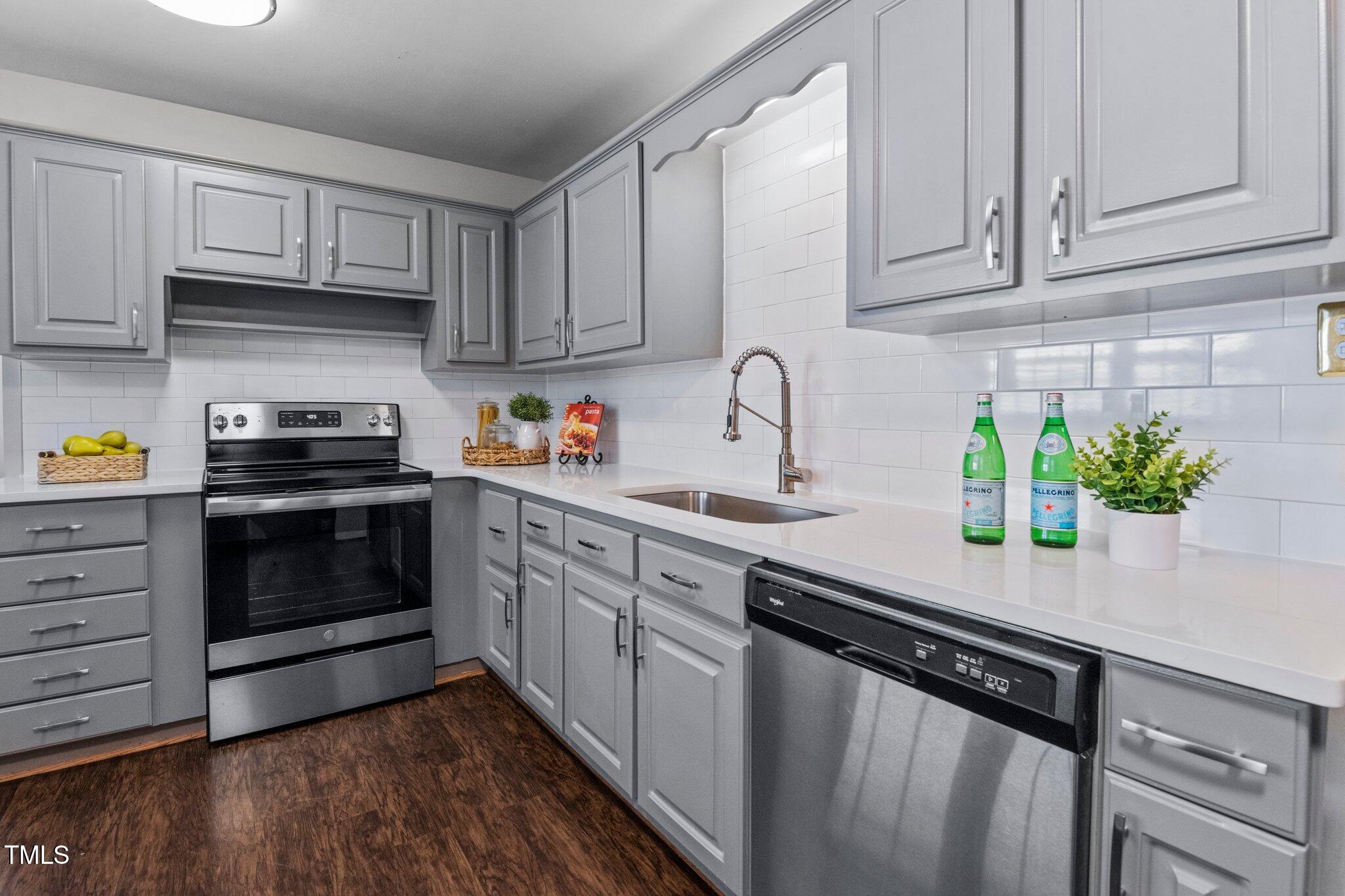 530 Banks Street Raleigh, NC 27604 - Photo 11 of 50 a kitchen with granite countertop white cabinets and a stove