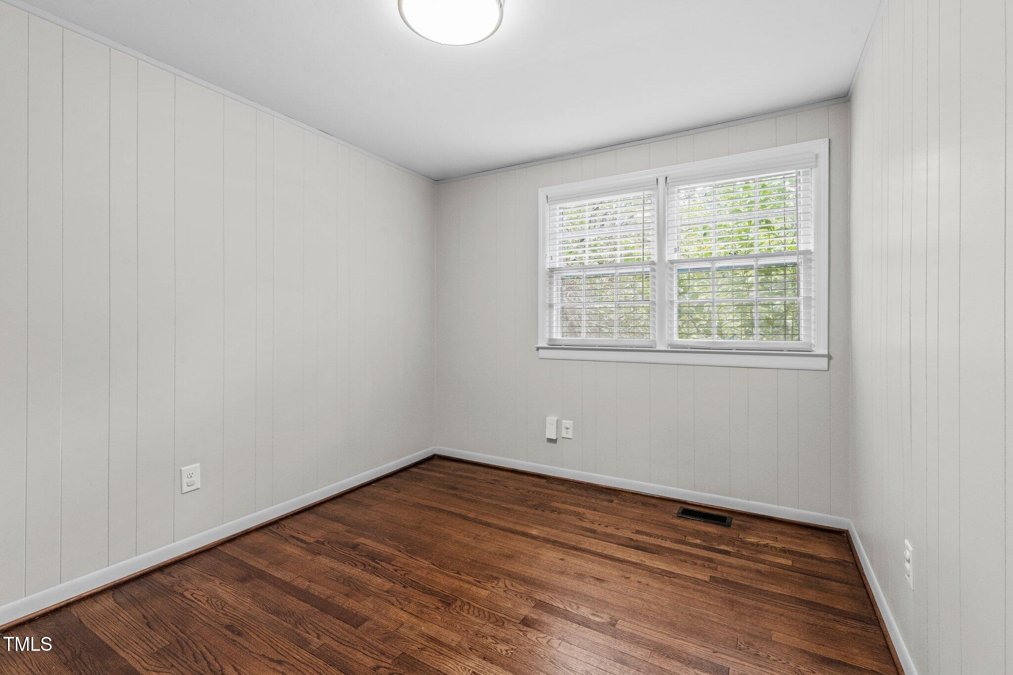 530 Banks Street Raleigh, NC 27604 - Photo 18 of 50 an empty room with wooden floor and windows