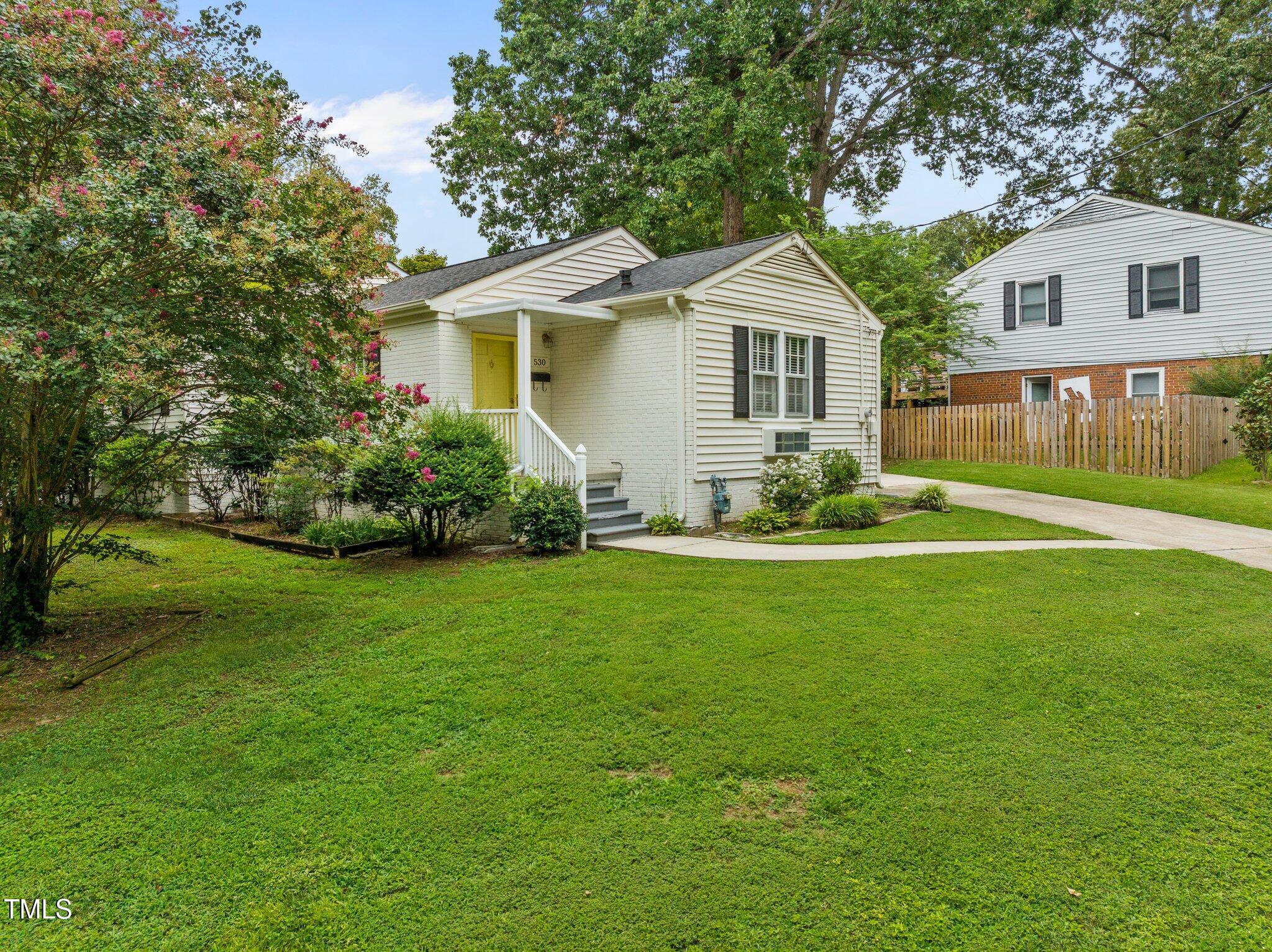 530 Banks Street Raleigh, NC 27604 - Photo 28 of 50 a front view of a house with a yard and garden