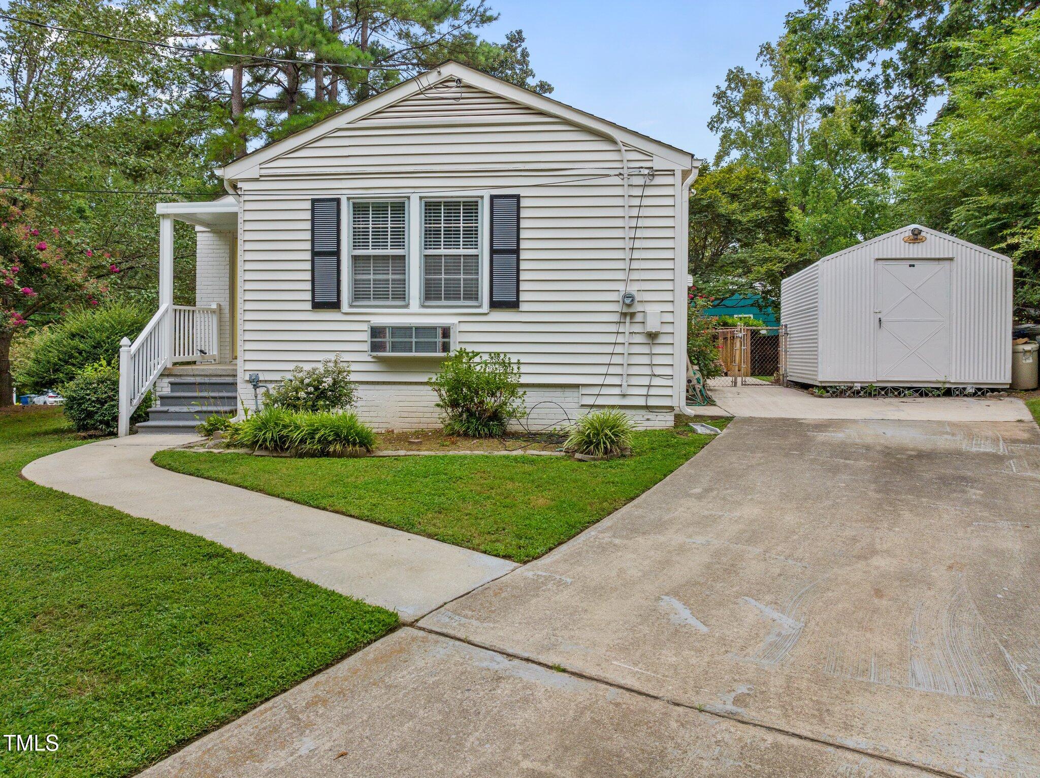 530 Banks Street Raleigh, NC 27604 - Photo 29 of 50 a front view of a house with a yard and a garage