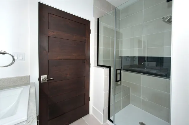 a bathroom with a shower and a sink