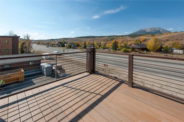 a view of a balcony with wooden floor and city view