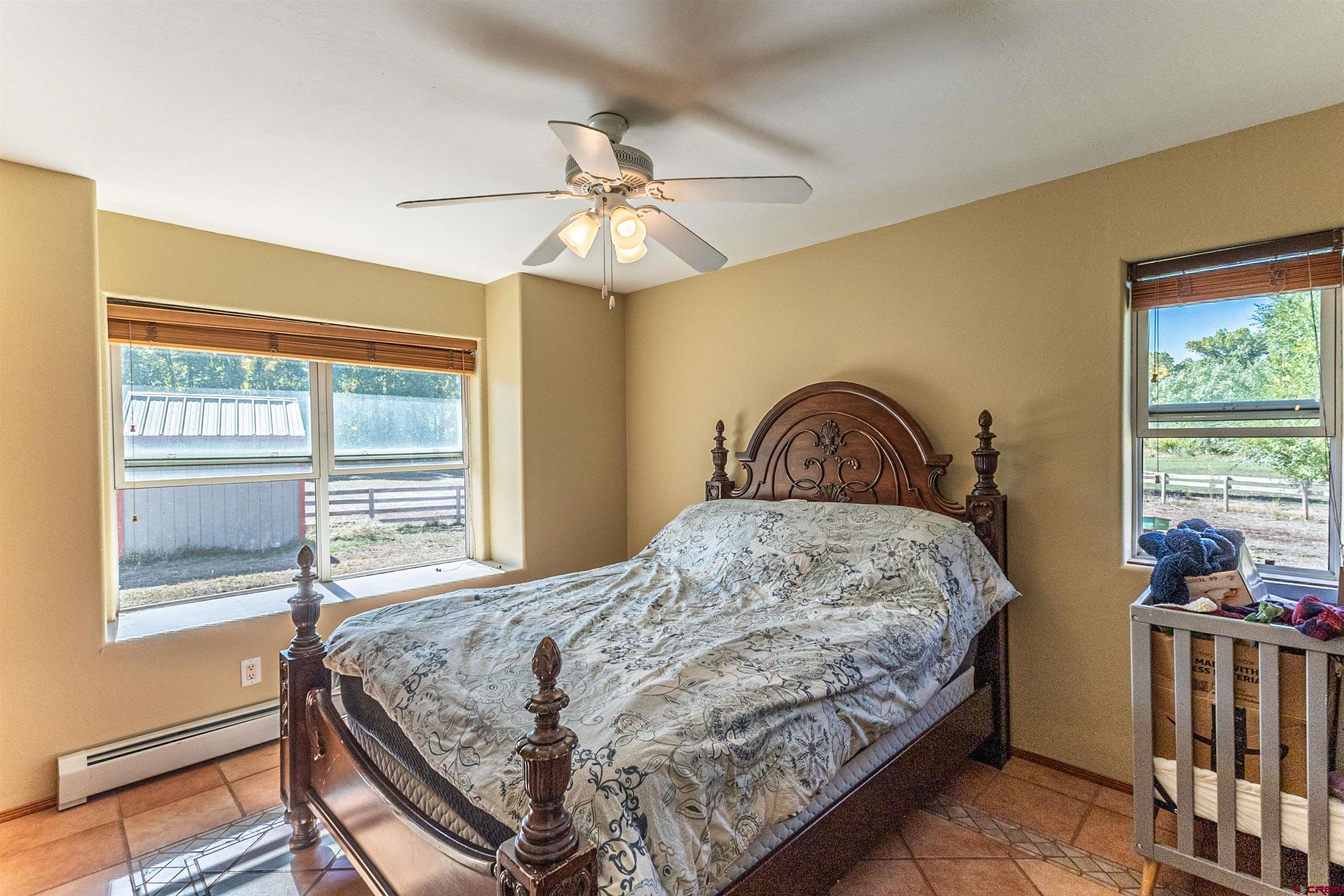 18 Road 2617 Aztec, NM 87410 - Photo 14 of 45 a bedroom with a bed and a window