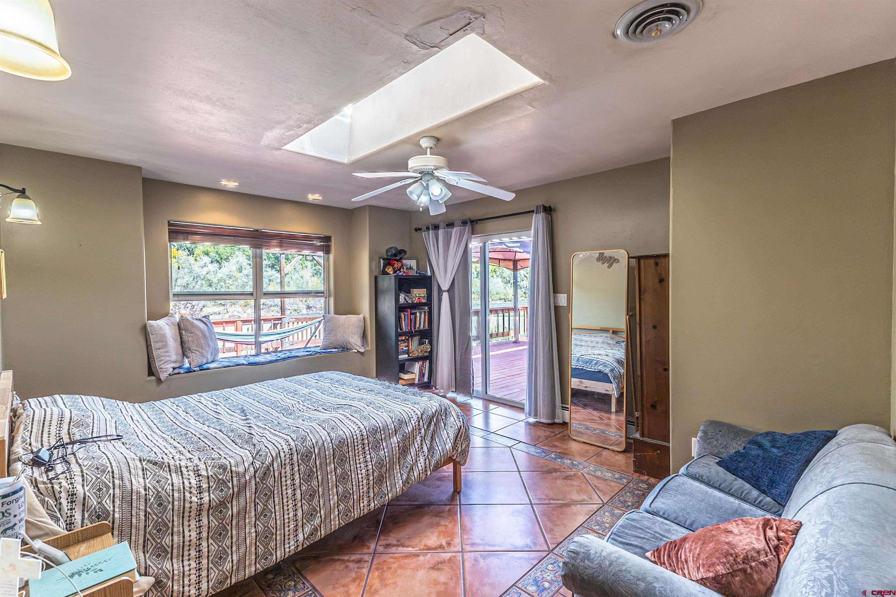 18 Road 2617 Aztec, NM 87410 - Photo 17 of 45 a spacious bedroom with a bed and glass windows