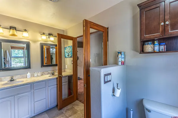 a spacious bathroom with a double vanity sink and a mirror