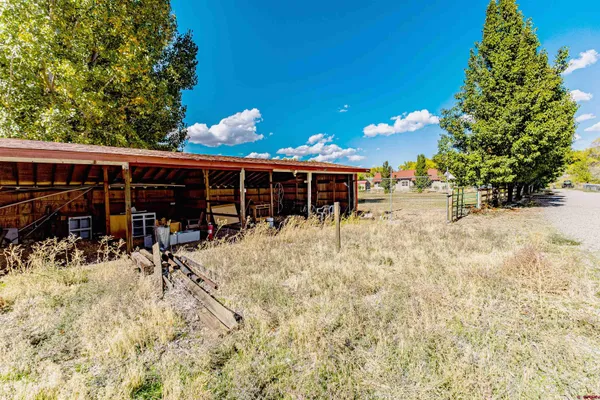 a view of a house with a yard patio and sitting area