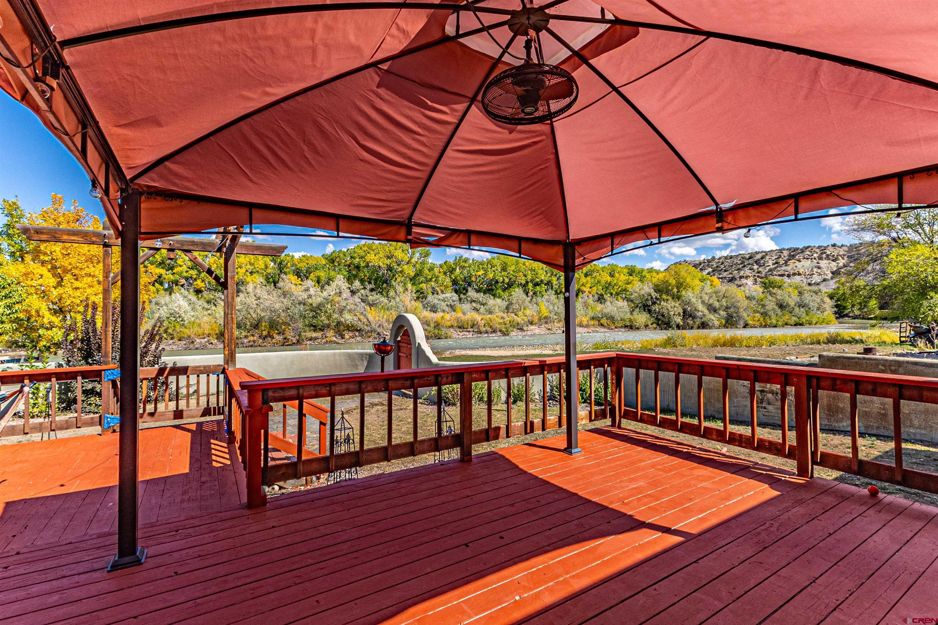 18 Road 2617 Aztec, NM 87410 - Photo 34 of 45 a view of a roof deck with table and chairs under an umbrella