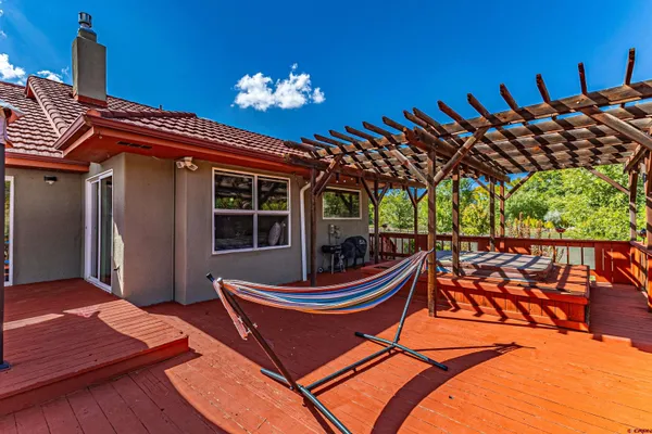 a backyard of a house with barbeque oven table and chairs